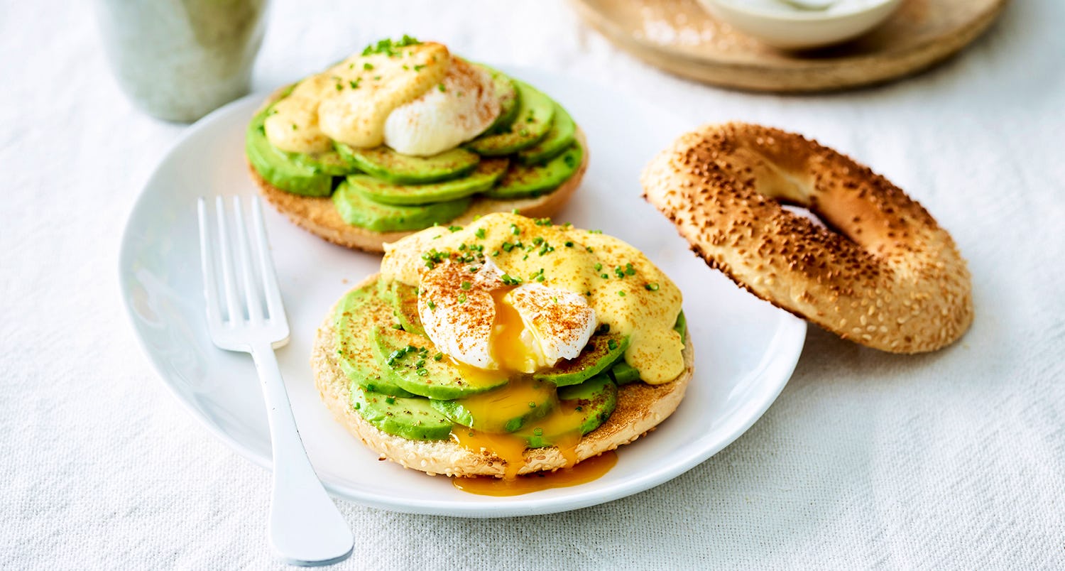 bagels topped with avocado and egg